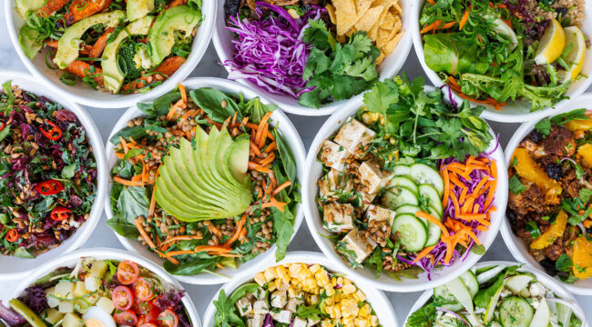 Top view of 9 different salads in white bowls